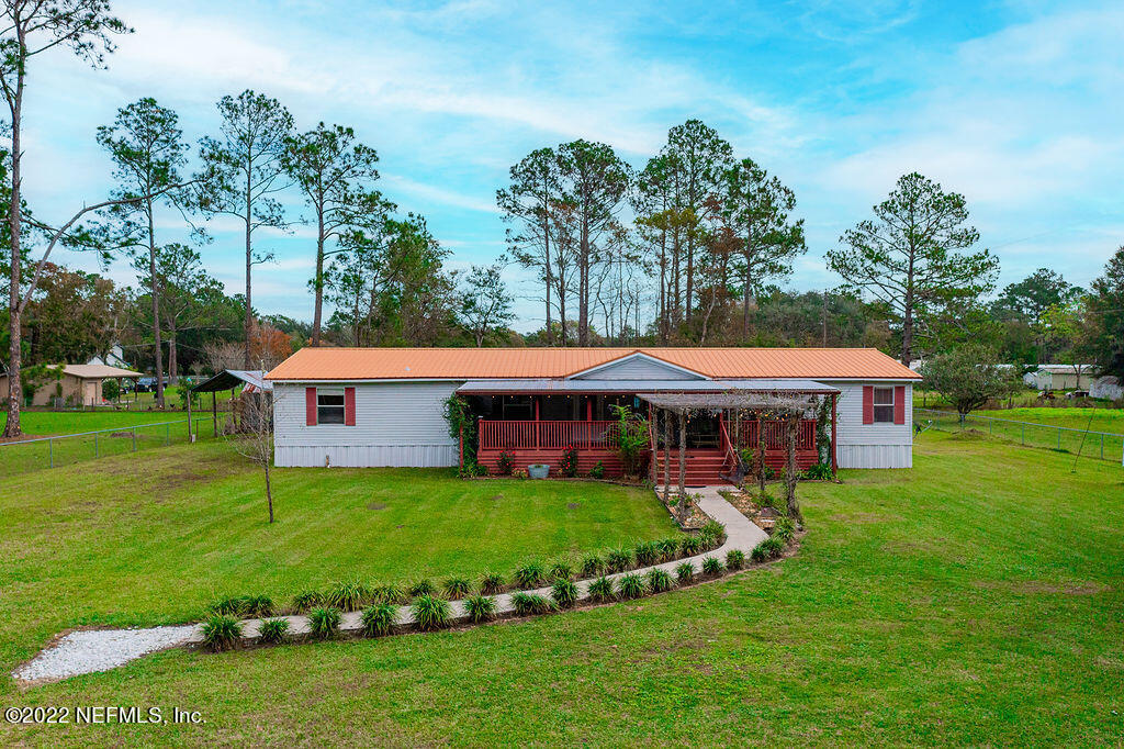 a front view of house with yard and green space