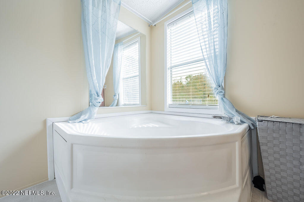 540532 Lem Turner Road Callahan, FL 32011 - Photo 23 of 62 a bath tub sitting in a bathroom next to a window