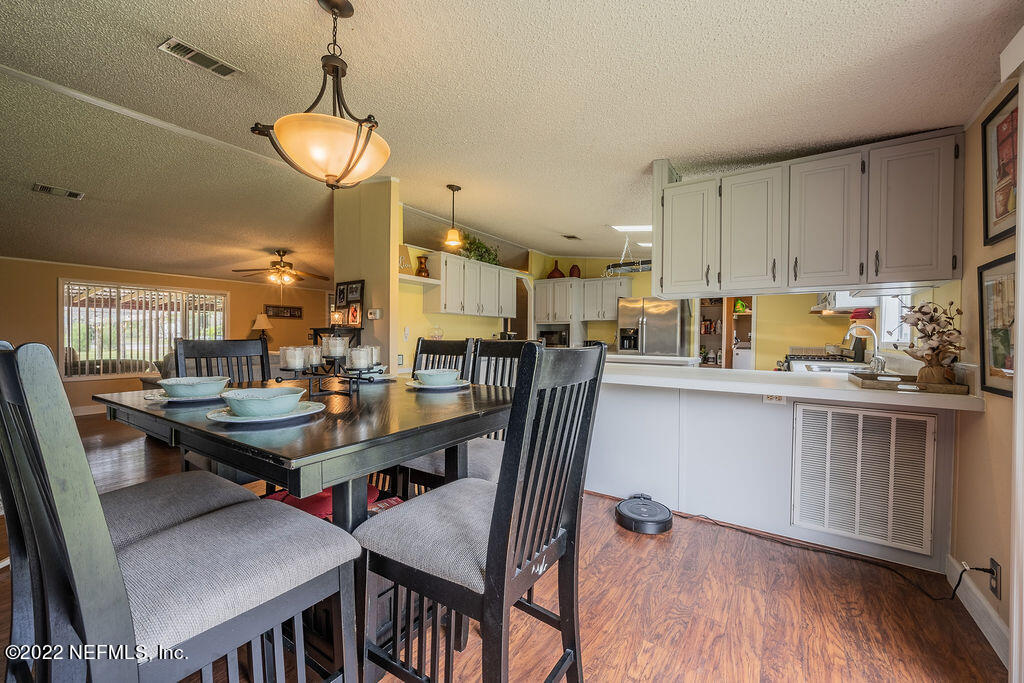 540532 Lem Turner Road Callahan, FL 32011 - Photo 27 of 62 a kitchen with a table chairs stove and cabinets