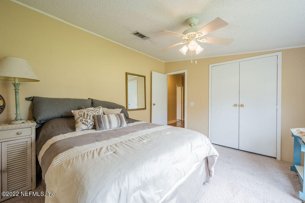 540532 Lem Turner Road Callahan, FL 32011 - Photo 45 of 62 a bedroom with a bed and a chandelier