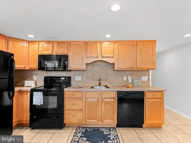a kitchen with stainless steel appliances a stove sink and cabinets