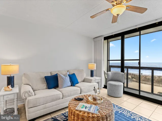a living room with furniture a lamp and a table