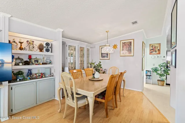 a dining room with furniture and wooden floor