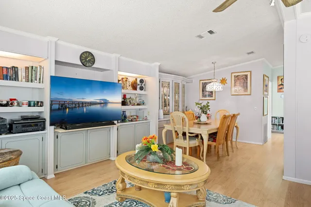 a living room with furniture and a dining table