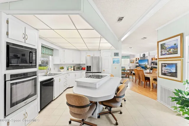 a kitchen with stainless steel appliances granite countertop a stove and a refrigerator