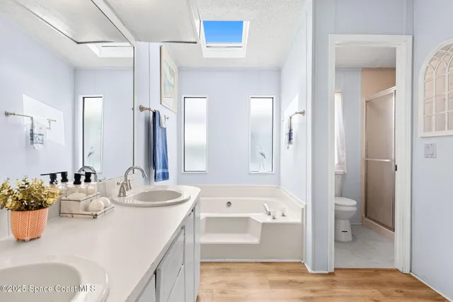 a bathroom with a tub sink and mirror