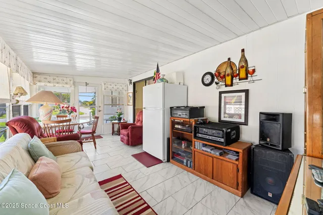 a view of a white building with swimming pool in front of it