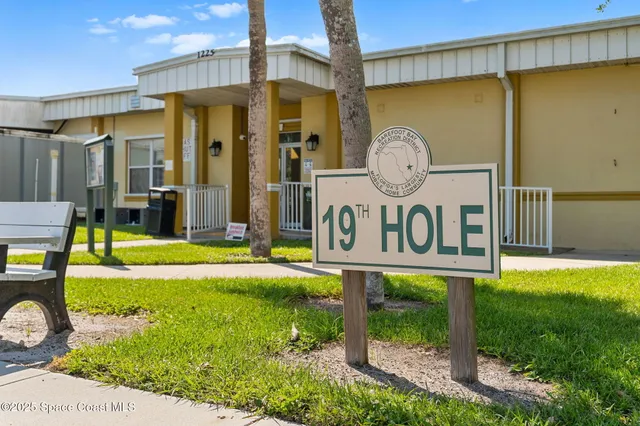 an aerial view of a house with a yard basket ball court and outdoor seating