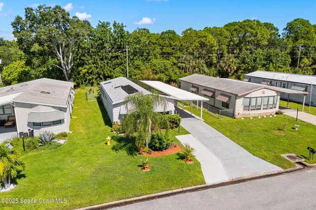 an aerial view of residential houses with outdoor space and swimming pool