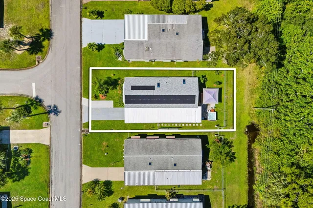 an aerial view of a swimming pool and outdoor space