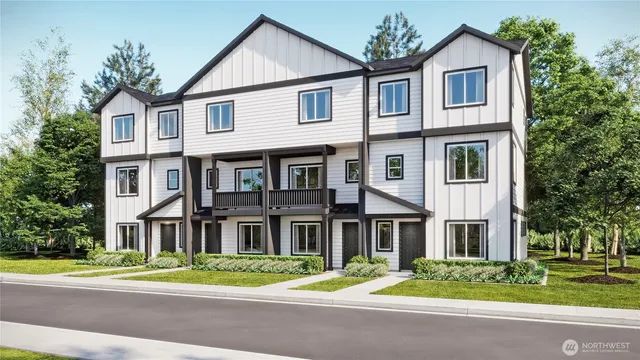 a view of a brick house with a yard plants and trees