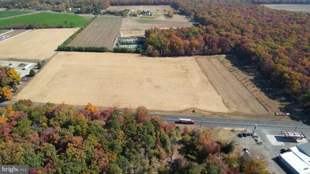 an aerial view of a house with a yard and mountain