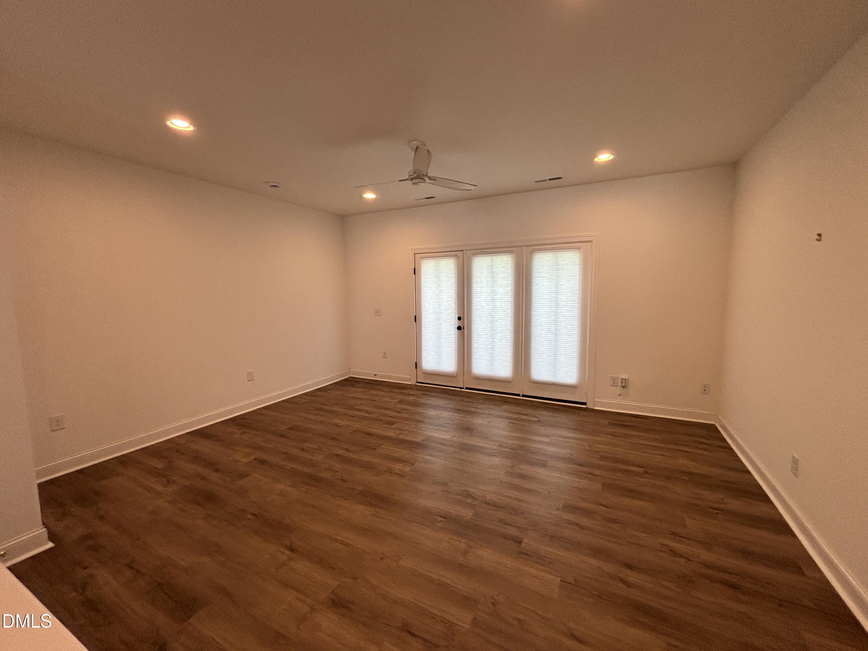 5710 Parker Pnes Court Raleigh, NC 27609 - Photo 19 of 78 an empty room with wooden floor and windows