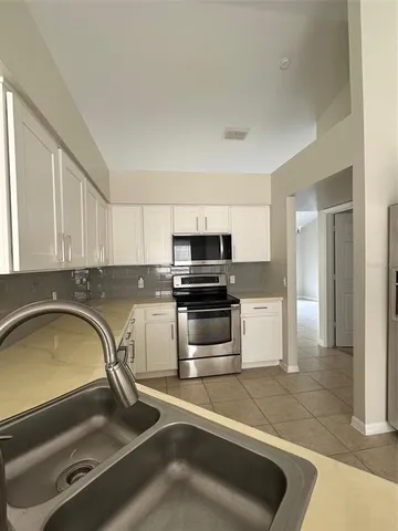 a kitchen with a sink and stainless steel appliances