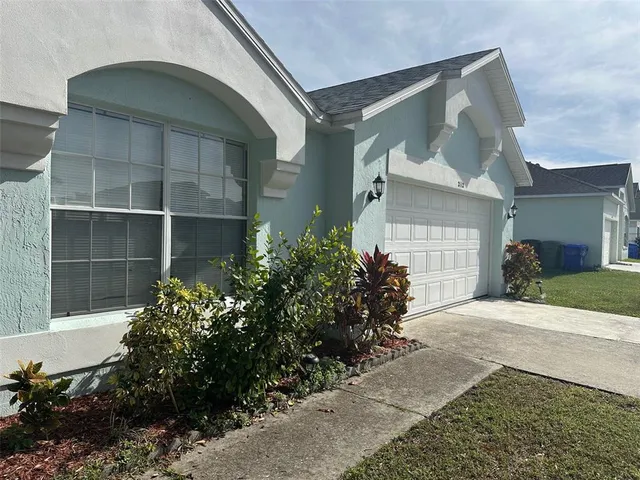 a view of a house with a flower garden