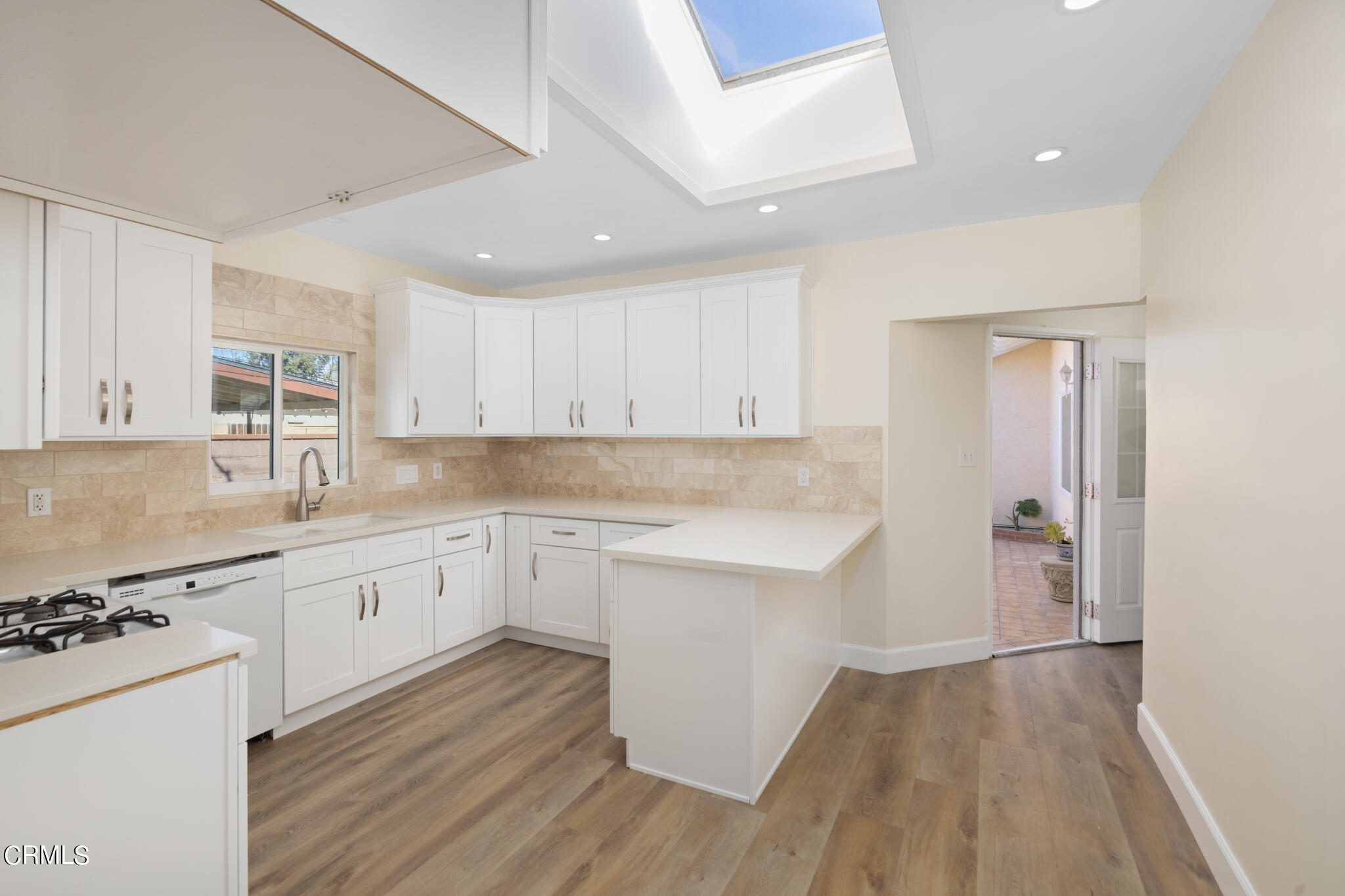 4516 Earle Avenue Rosemead, CA 91770 - Photo 5 of 23 a kitchen with granite countertop white cabinets and white appliances