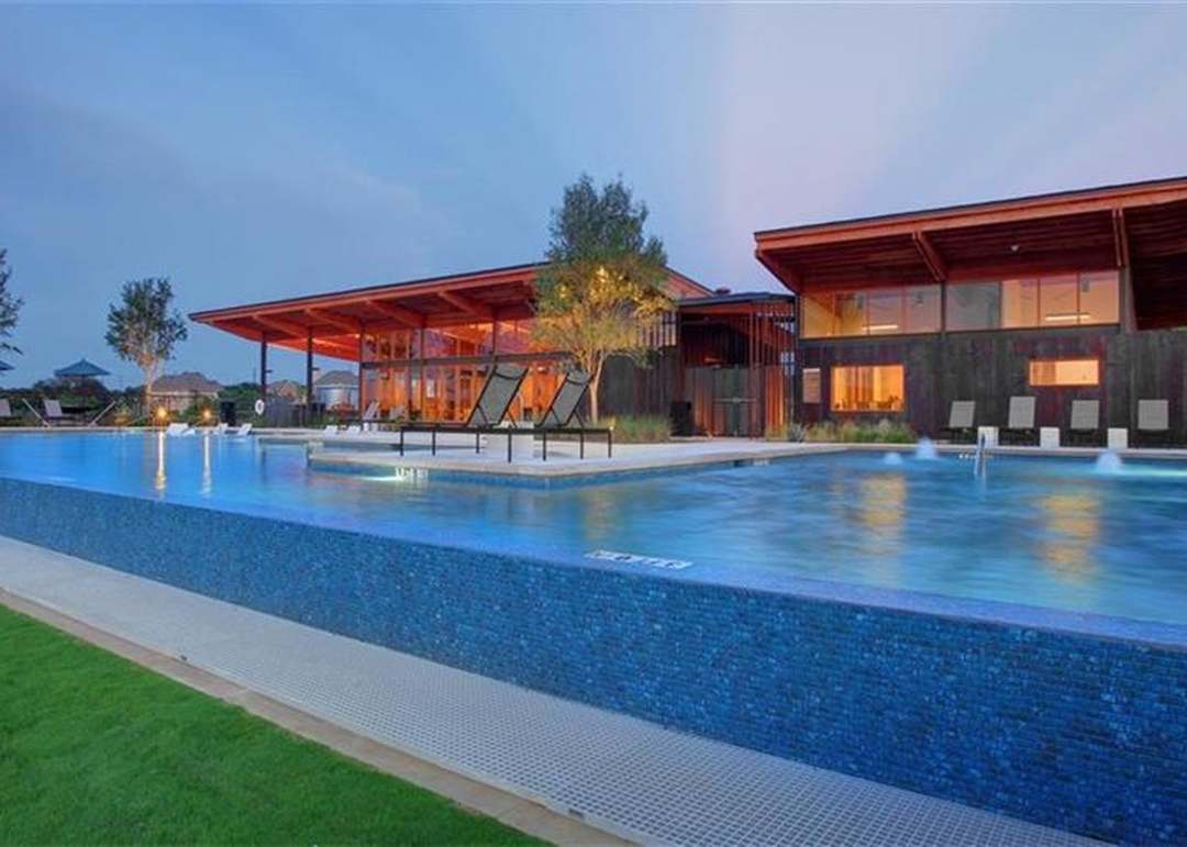 208 Wolf Springs Road Georgetown, TX 78628 - Photo 30 of 32 An inviting infinity pool and chic community clubhouse create a perfect outdoor retreat.