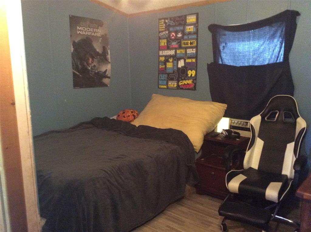 8762 Private Road 4641 Baird, TX 79504 - Photo 15 of 36 a bedroom with a bed and wooden floor