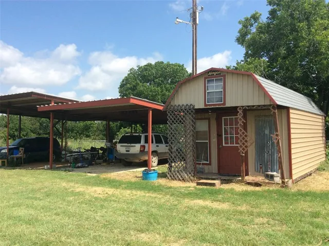 a front view of a house with a yard table and chairs