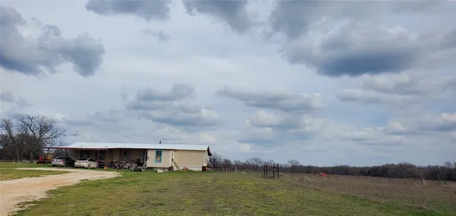 a view of house with river and lake in the background