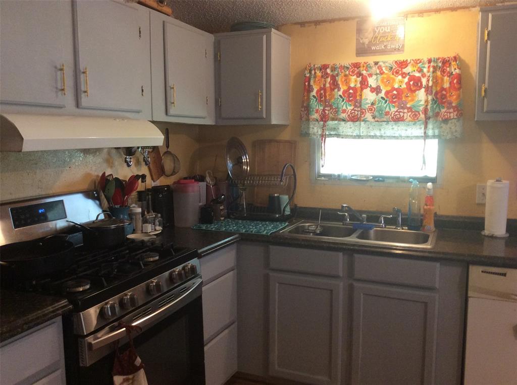 8762 Private Road 4641 Baird, TX 79504 - Photo 6 of 36 a kitchen with a sink and cabinets