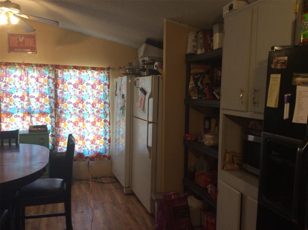 8762 Private Road 4641 Baird, TX 79504 - Photo 7 of 36 a kitchen with a refrigerator and window