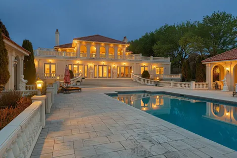 a view of a swimming pool with sitting area