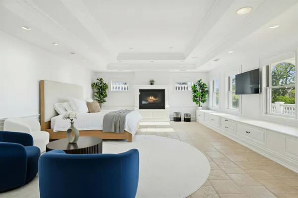 a living room with furniture a large window and a potted plant