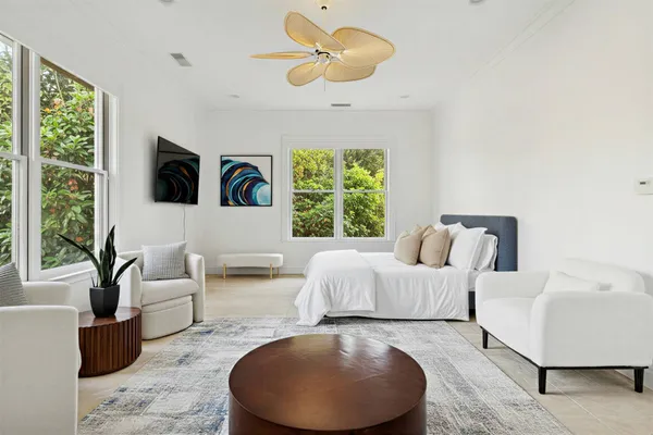 a spacious bedroom with two beds and a chandelier
