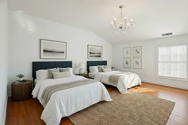 a bathroom with a granite countertop sink a mirror and shower