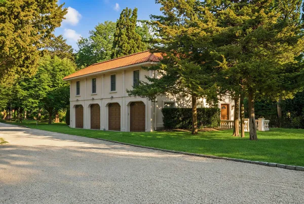 an aerial view of a house with a garden and trees