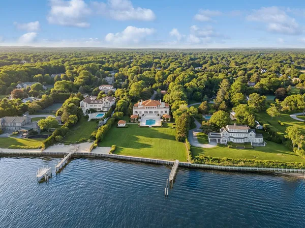 an aerial view of residential houses with outdoor space and trees