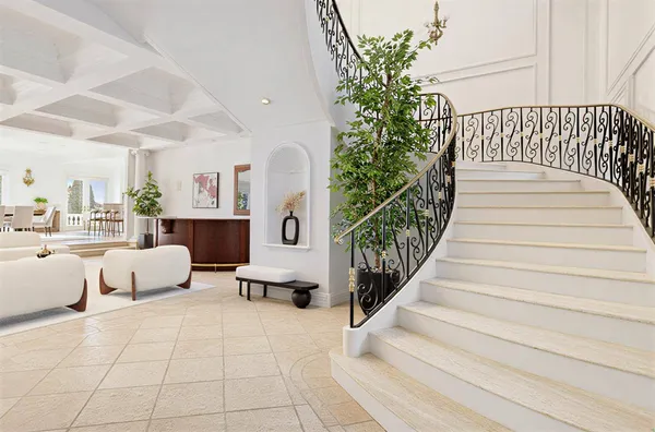 a large white kitchen with a large window and furniture