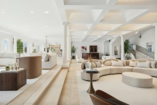 a dining hall with stainless steel appliances kitchen island granite countertop a sink and cabinets