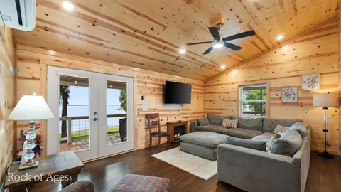 a view of a dining room with furniture a kitchen and chandelier