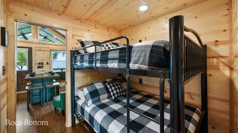 a bathroom with a granite countertop sink a toilet a mirror and shower