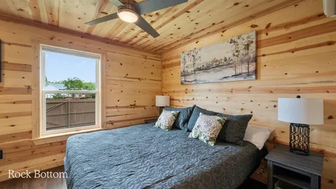 a bedroom with a bed and a desk