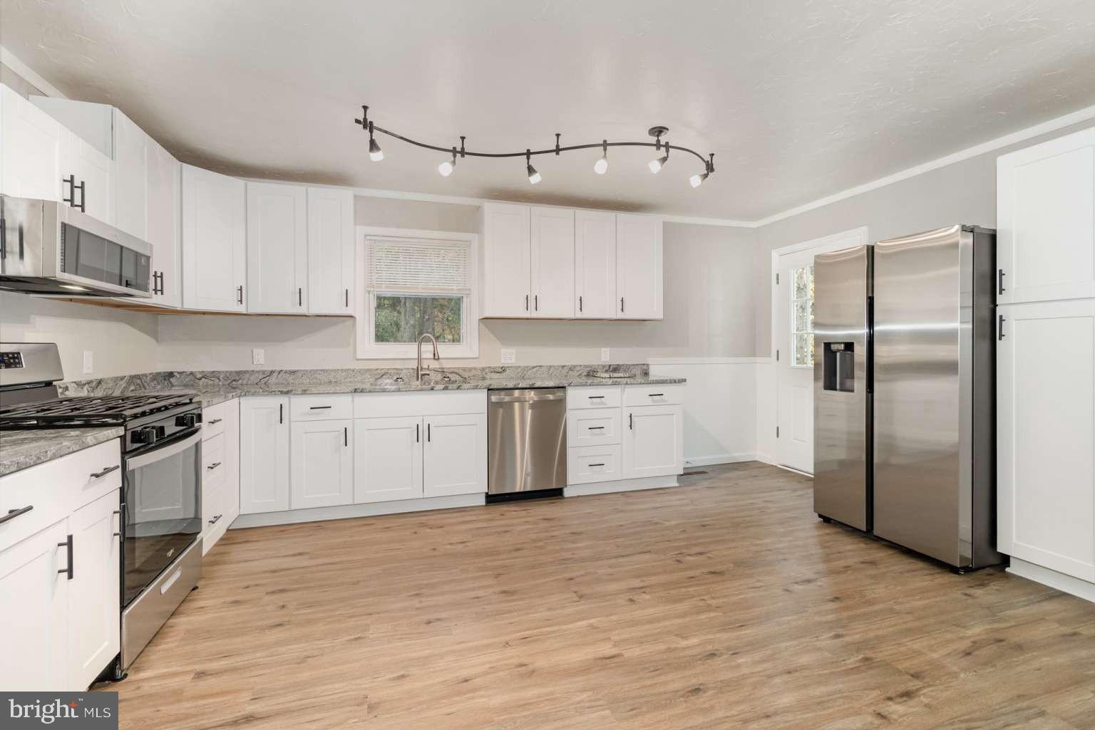475 Company Farm Road Aspers, PA 17304 - Photo 16 of 45 a kitchen with stainless steel appliances cabinets a sink and a stove