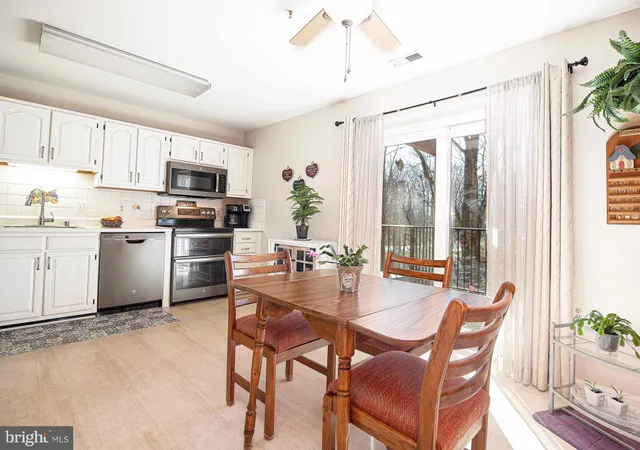 a kitchen with microwave a stove and furniture