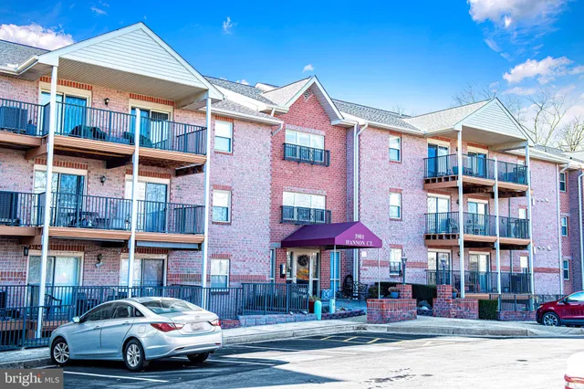 a view of a car park in front of a brick building