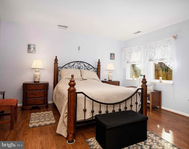 a bedroom with furniture and a wooden floor