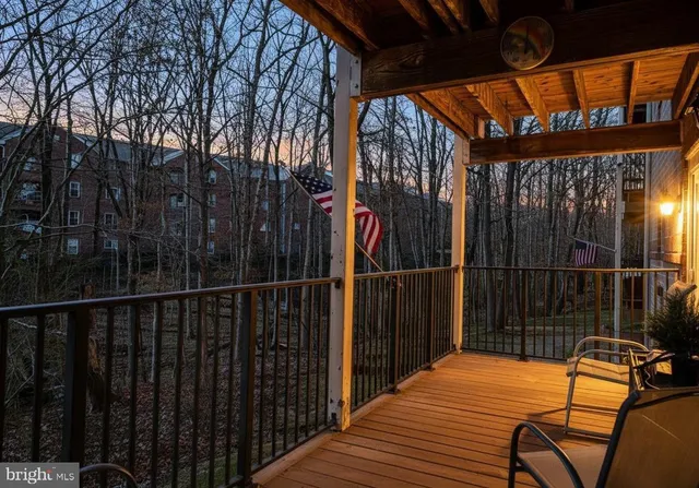 a view of balcony with wooden floor and outdoor seating