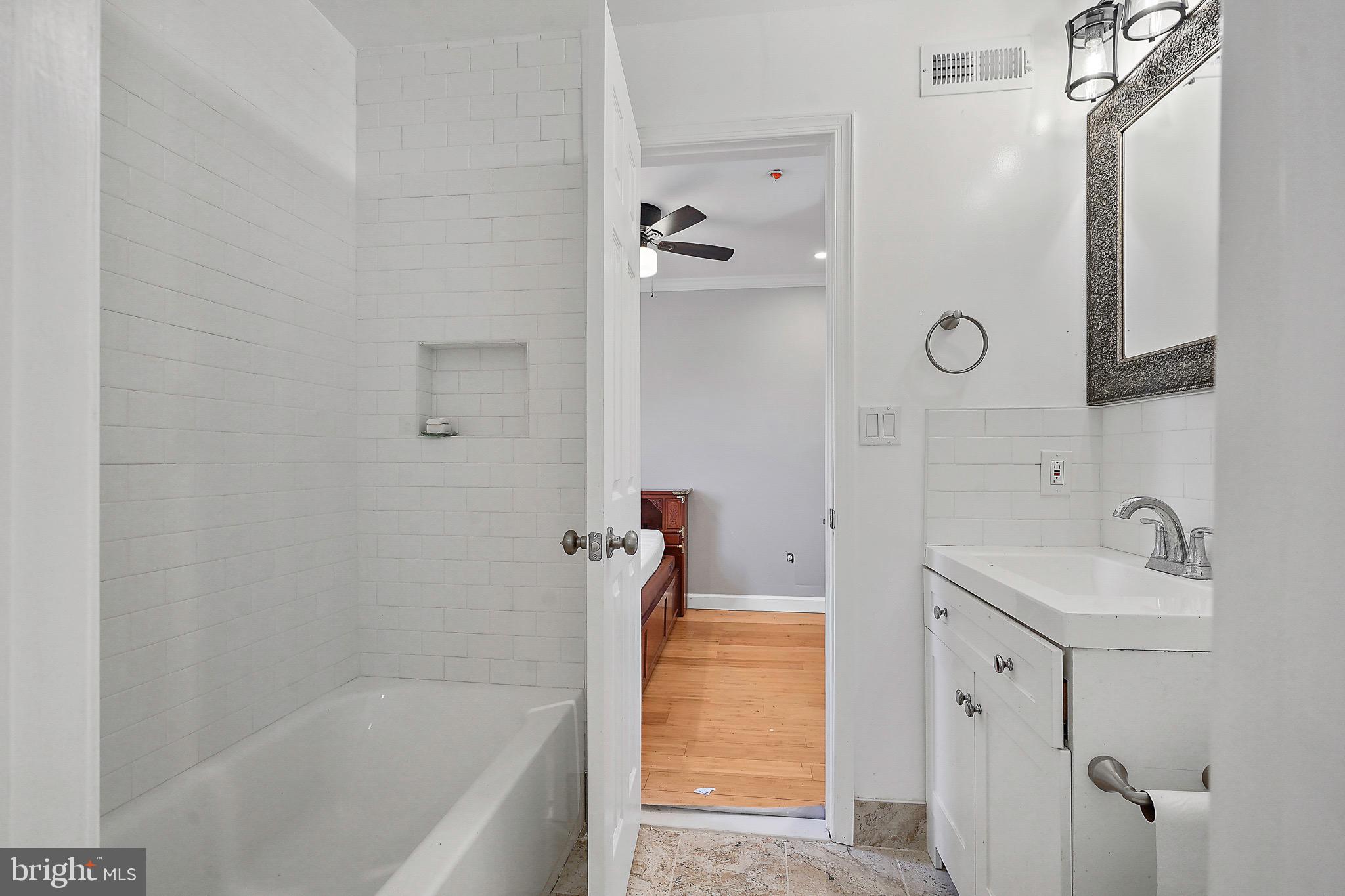 7419 Farnum Street Springfield, VA 22151 - Photo 15 of 26 a bathroom with a tub sink and mirror