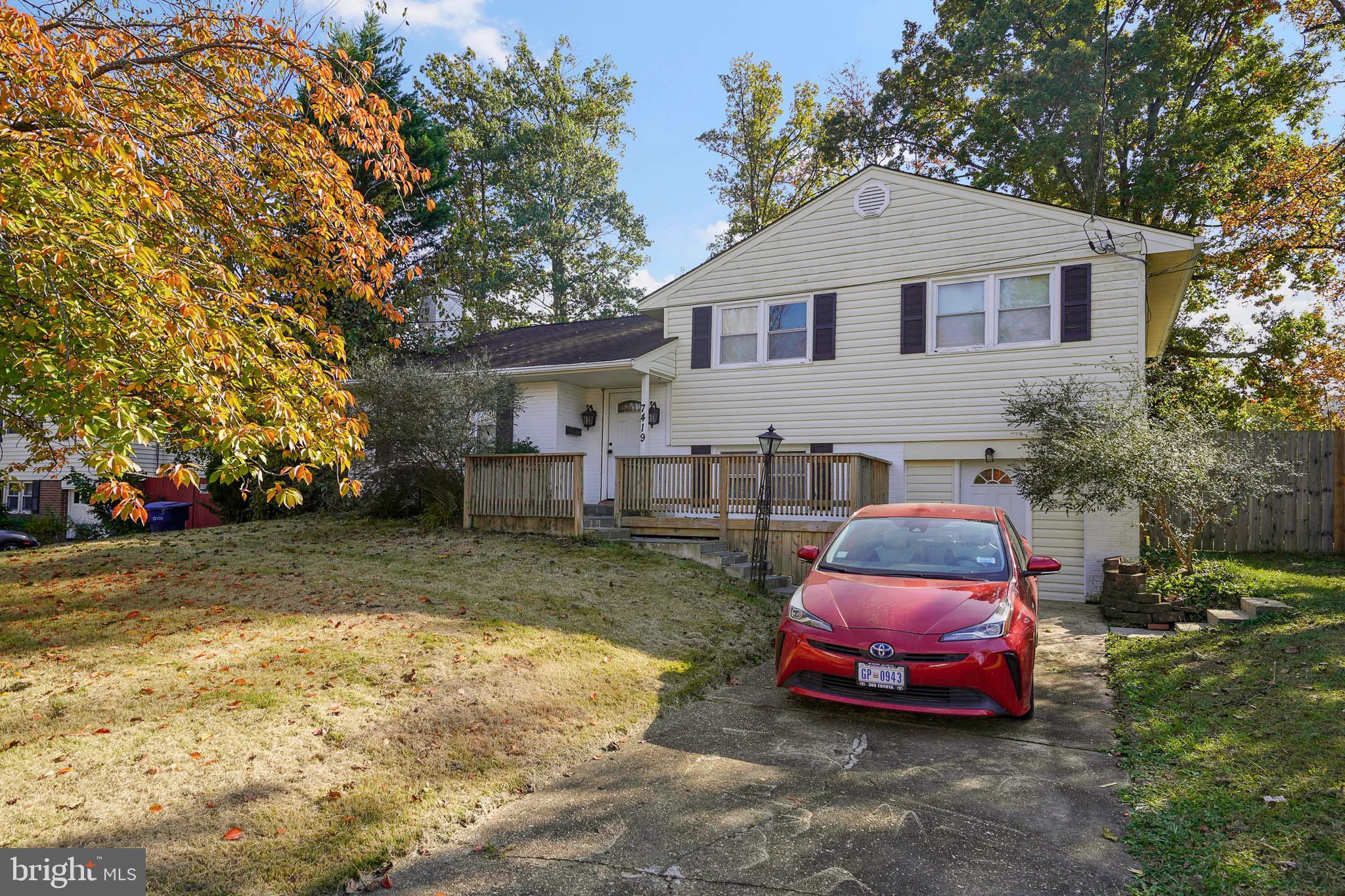 7419 Farnum Street Springfield, VA 22151 - Photo 22 of 26 a front view of a house with a garden and parking space