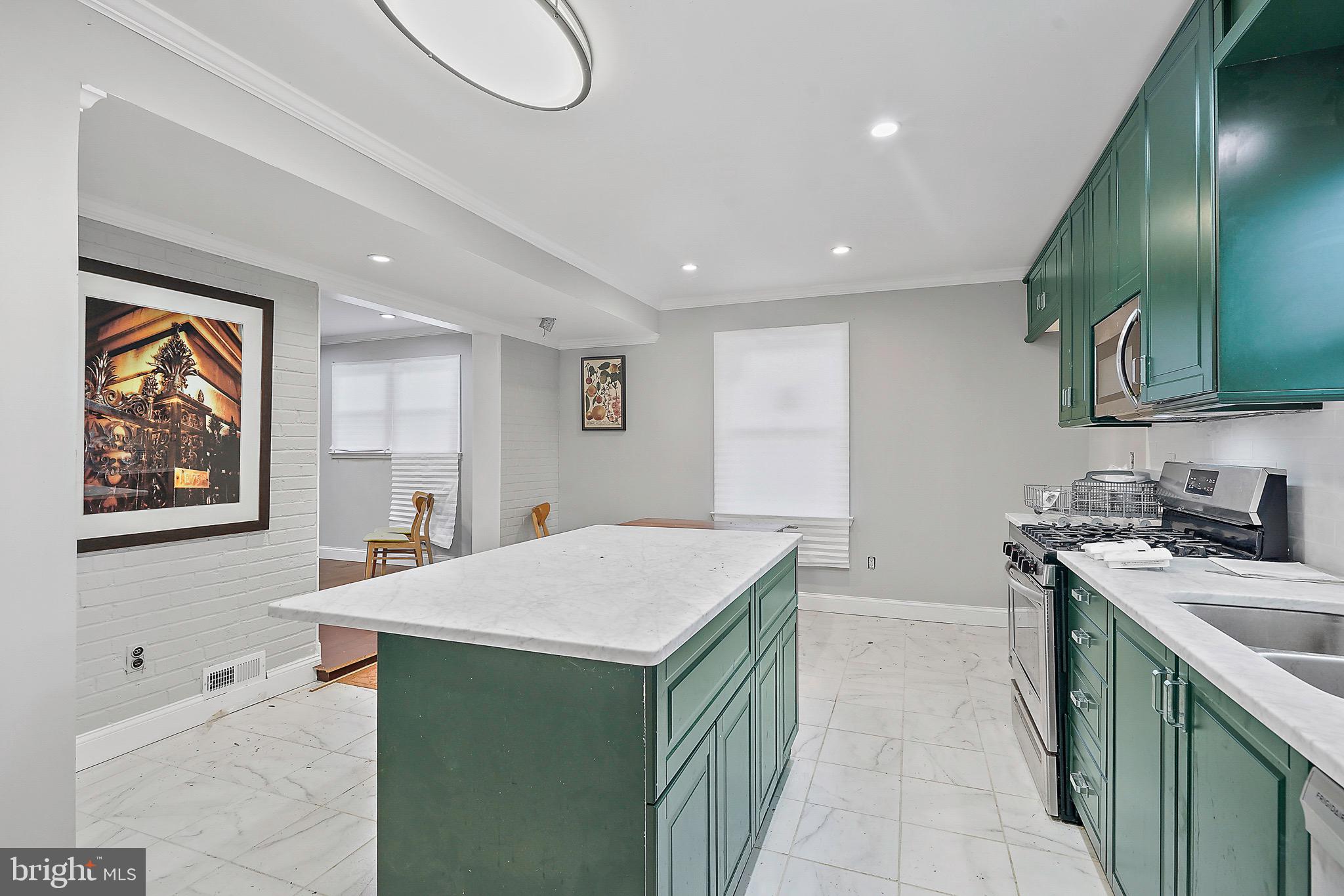 7419 Farnum Street Springfield, VA 22151 - Photo 5 of 26 a kitchen that has a sink a stove and a table