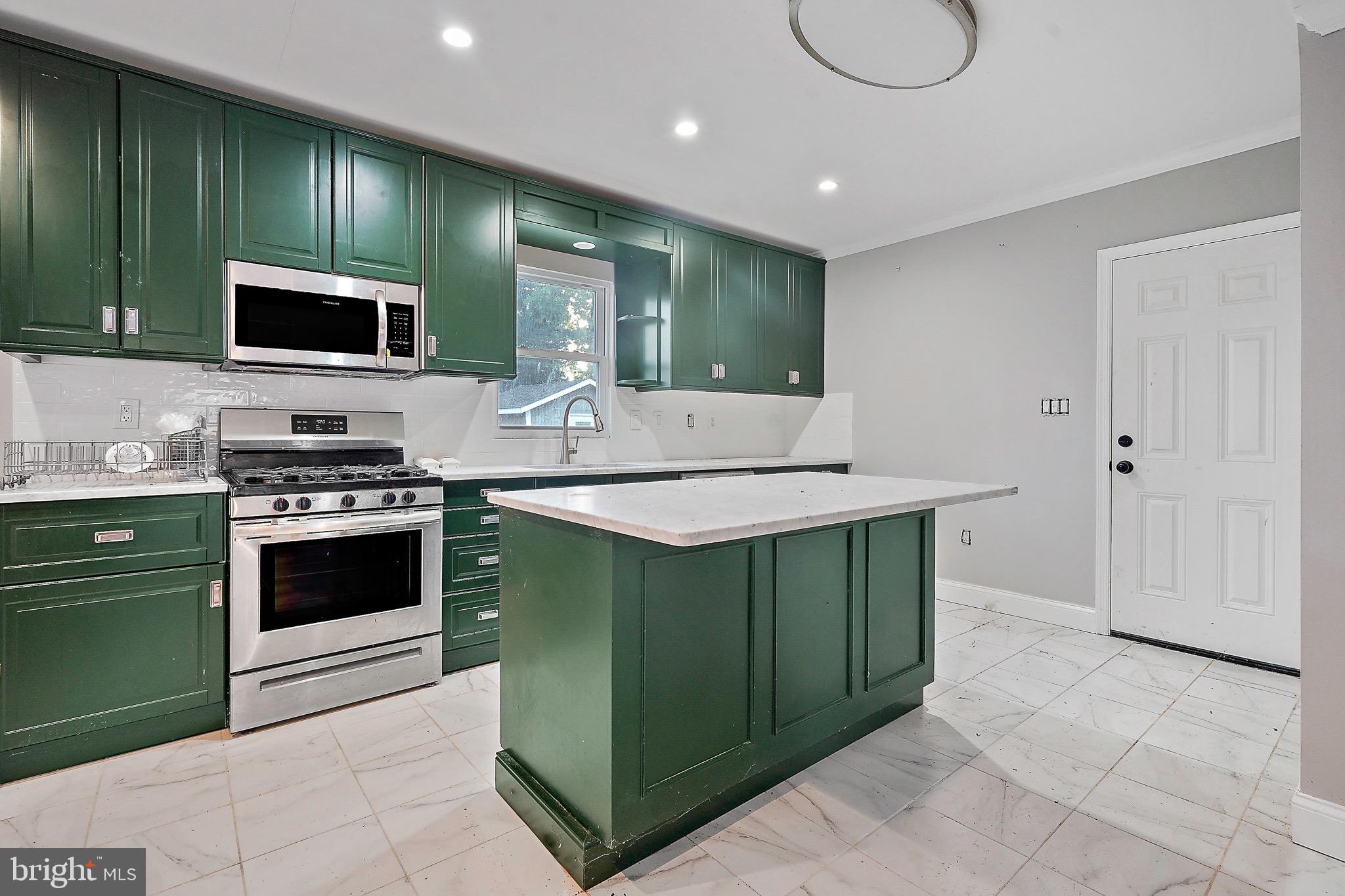 7419 Farnum Street Springfield, VA 22151 - Photo 6 of 26 a kitchen with kitchen island granite countertop a sink and a stove top oven