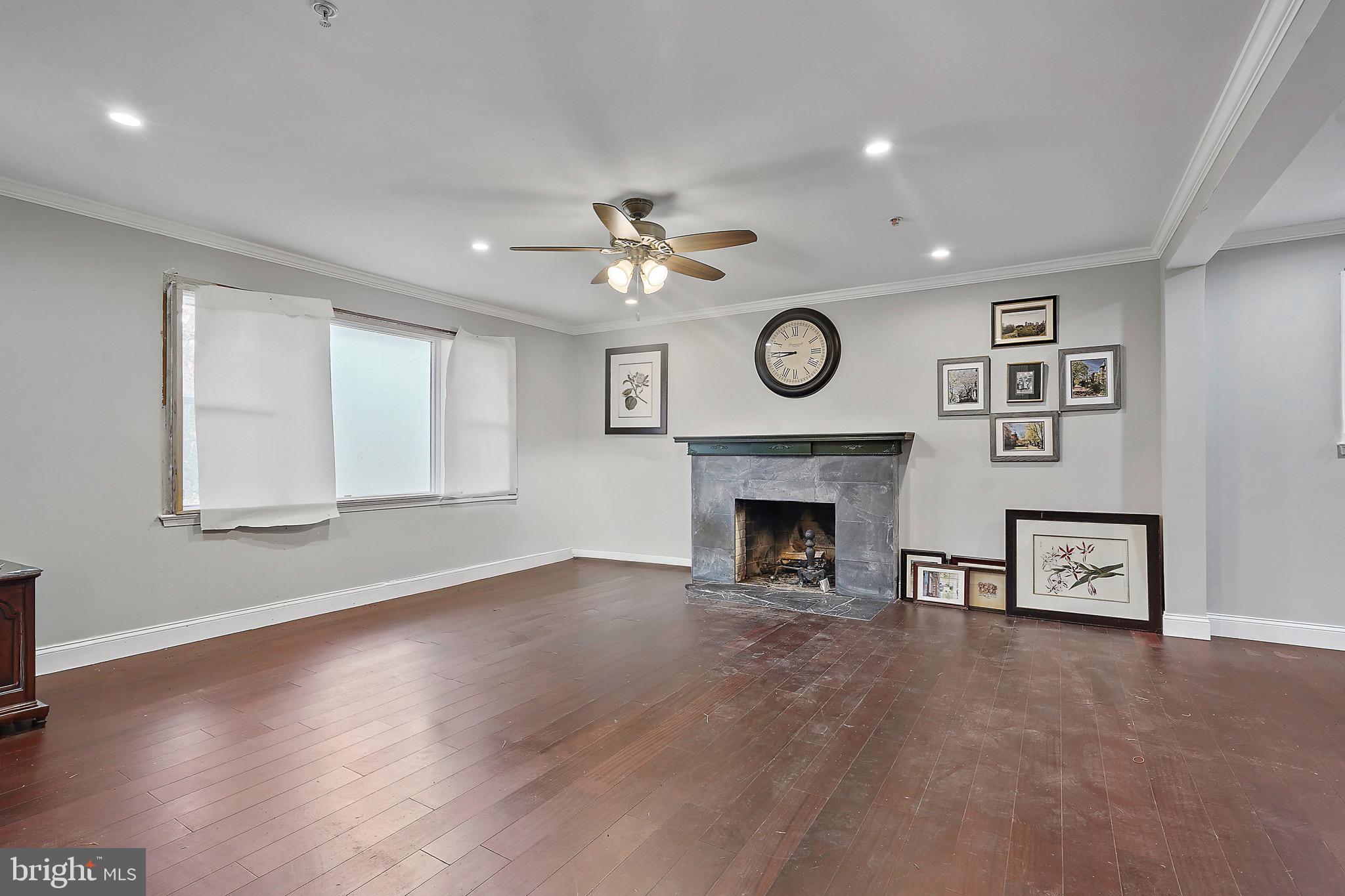7419 Farnum Street Springfield, VA 22151 - Photo 9 of 26 a view of a livingroom with a fireplace a fan and a large window