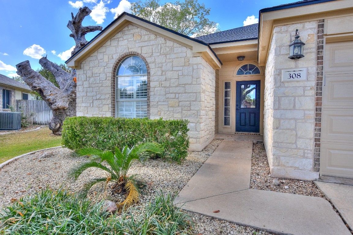 308 Adkins Cove Georgetown, TX 78626 - Photo 1 of 1 a front view of a house with garden