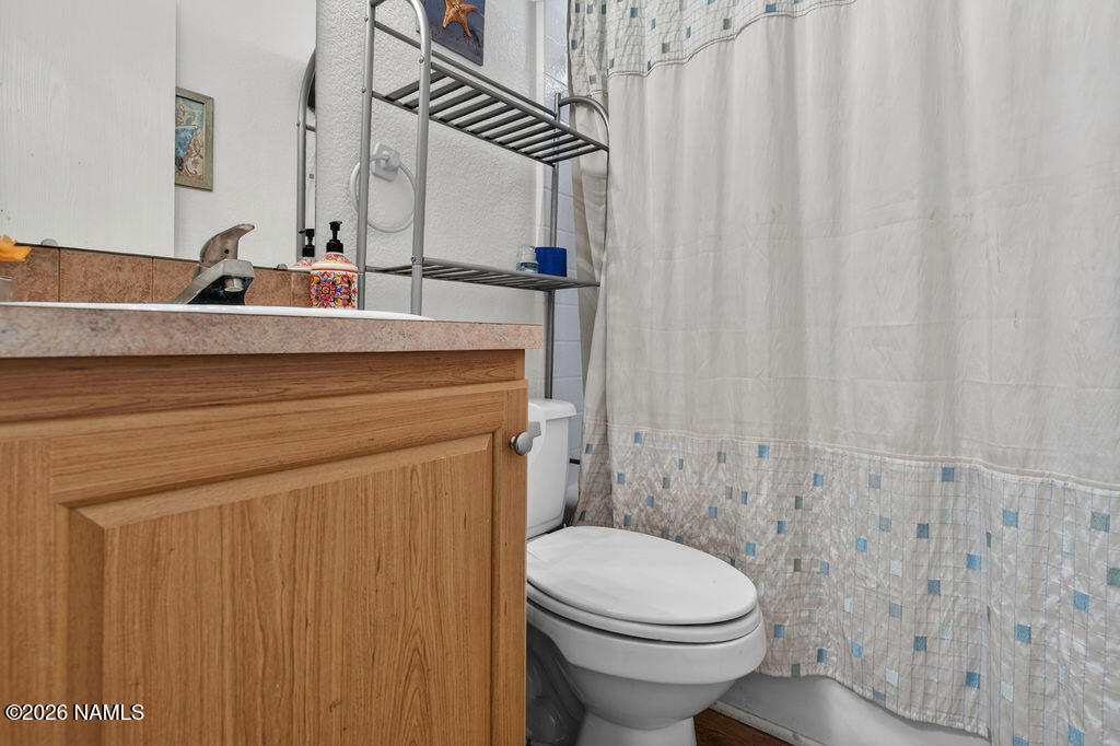 17550 South Munds Ranch Road, Unit 343 Munds Park, AZ 86017 - Photo 23 of 31 a bathroom with a sink a toilet and shower