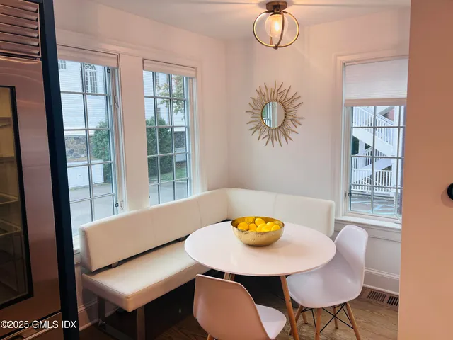 a view of a dining room with furniture and window